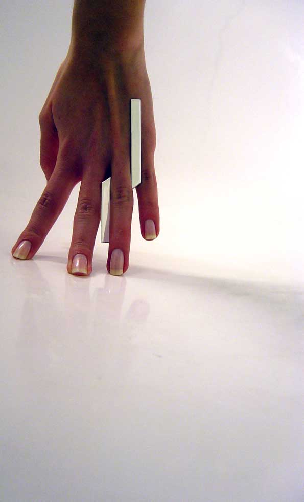 Photo of hand wearing silver ring.